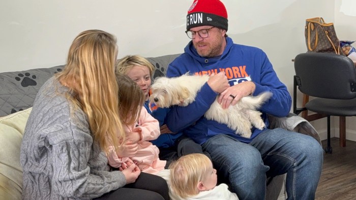 Christopher Prizeman with wife and children, holding their new puppy. 