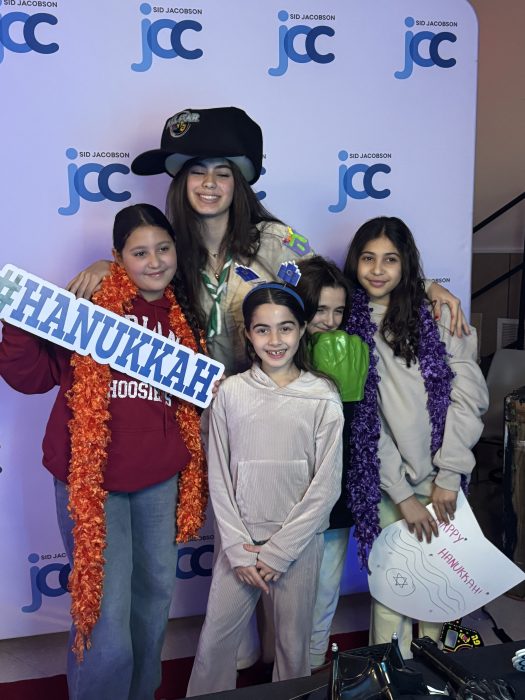 Children posing for a photo during Sid Jacobson JCC's Community Hanukkah Celebration.