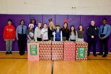 John Lewis Childs School’s Student Council members and Advisers Marianna Antonakis and Christina Saunders are pictured with members of the NYPD on Dec. 19.