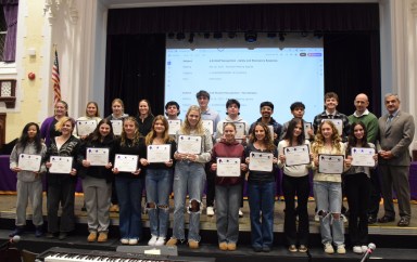 Oyster Bay-East Norwich athletes who received county and state-level honors were called forward during the meeting to receive certificates recognizing their achievements.