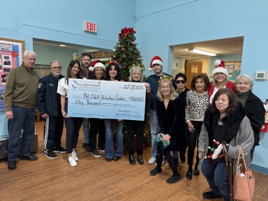 The Port Washington Adult Activities Center with a check from the Peter & Jeri Dejana Foundation.