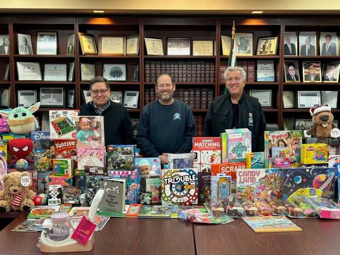 Plainview Water District Commissioner Andrew Bader, Commissioner Marc Laykind and Commissioner Michael Chad (L. to R.) with the Toys for Tot’s donations at the district's headquarters.