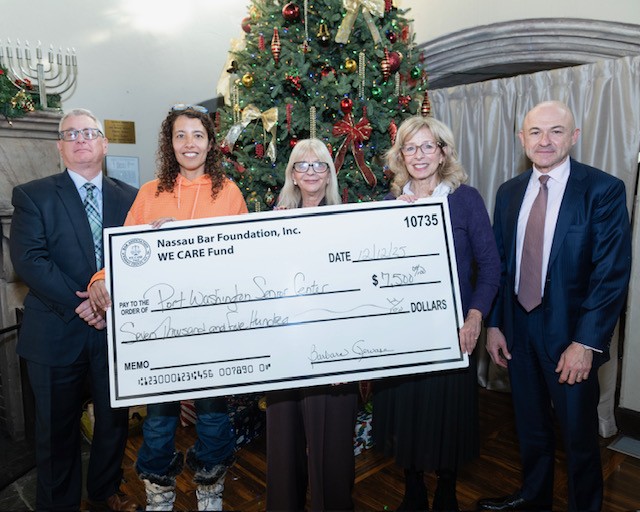Members of the WE CARE Fund and Port Washington Adult Activities Center with a grant for the center.