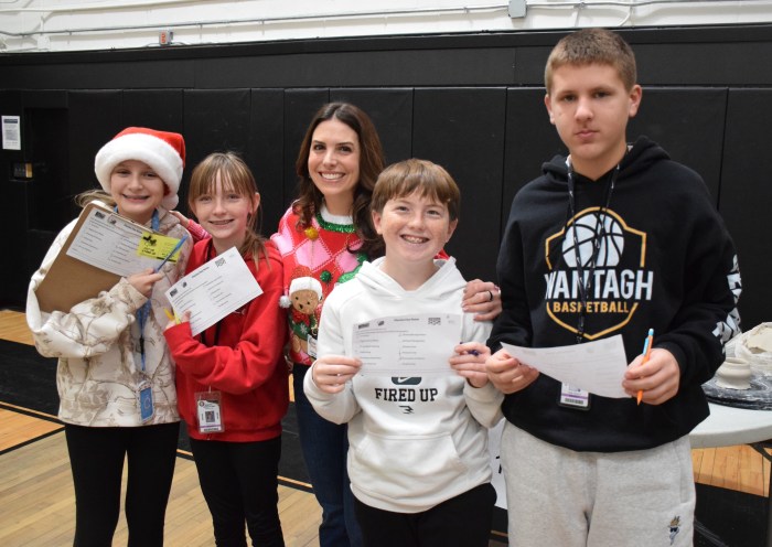Rachel Quattrocchi welcomed seventh graders Catherine Smolyaninova, Maeve Burke, Mason Fayda and Ryan Gerbore (L. to R.) to the fair, where they rated the courses they would want to take next year.