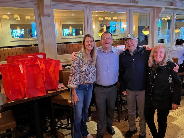 St. Peter of Alcantara volunteers with the owner of Sullivan's Quay.