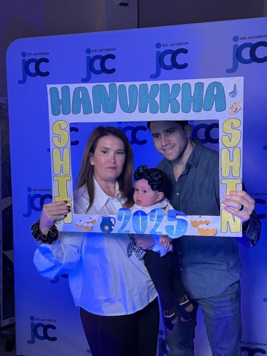 Families gathered for photo opportunities, celebrating the final night of Hanukkah.