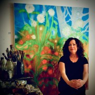 Port Washington based artist Rachelle Kreiger with her painting from her exhibit "Day Dreams and Night Visions" on show at the Port Washington Public Library.