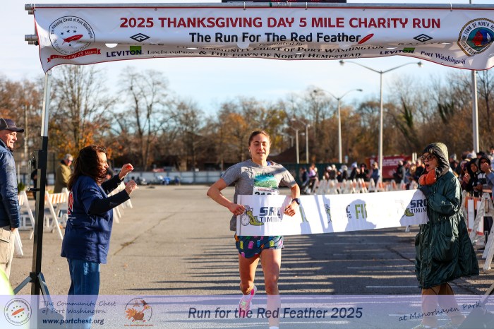 Lola Gitlin crossing the finish line.