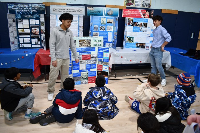 Middle and high school students present history lessons to younger students.