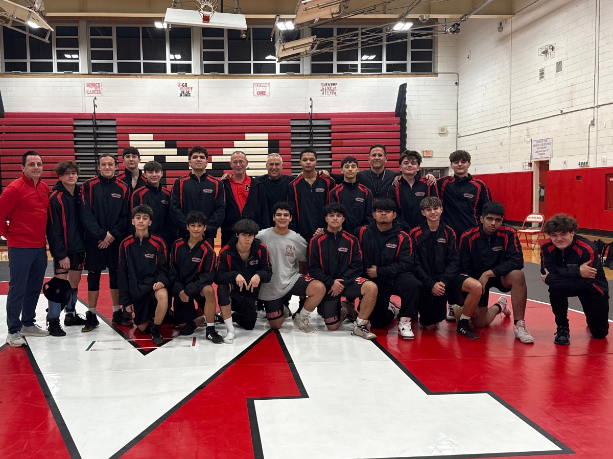 Mineola wrestling coach Dan Guido celebrates with student-athletes following historic 400th win as head coach