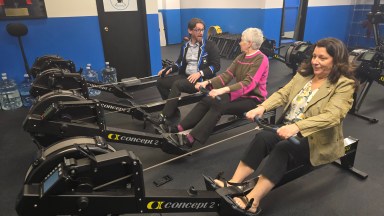 Council Member Mariann Dalimonte tested out rowing equipment at the new Port Rowing training facility.