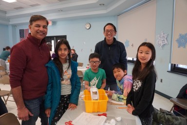 Students at Herricks’ Center Street Elementary School are joined by parents for the eleventh annual DeSTEMber Challenge, an event that encourages creativity and collaboration in an engineering activity.