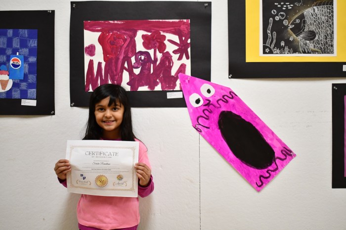 Student displays her work at the district's recognition show. 
