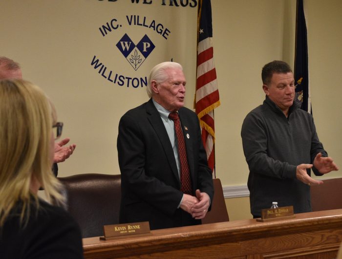 Mayor Paul Ehrbar (L.) addresses the public at a meeting for the Williston Park Board of Trustees.