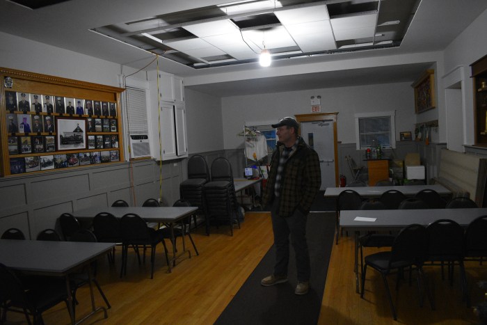 Former chief of the company Martin Tolan stands in the emptying firehouse.