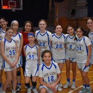Our Lady of Victory's girls' basketball team during half time at their first ever game.