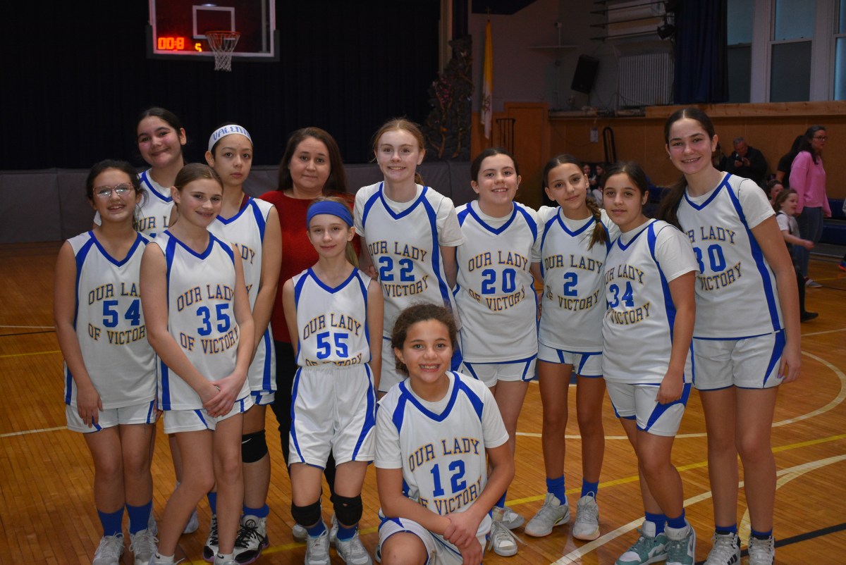 Our Lady of Victory's girls' basketball team during half time at their first ever game.