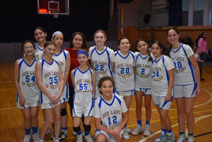 Our Lady of Victory's girls' basketball team during half time at their first ever game.