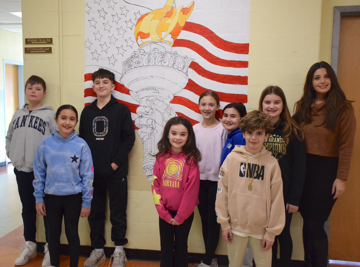 Forest Lake Elementary School art teacher Laura Capozzi was joined by fifth graders who are helping paint a new mural and third graders who suggested the design.