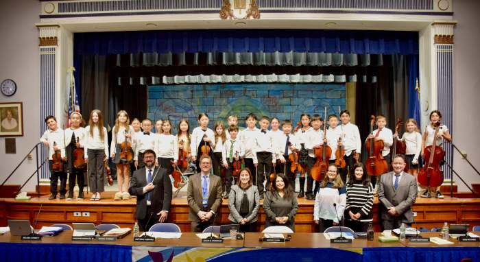 The student orchestra performed for district community members.