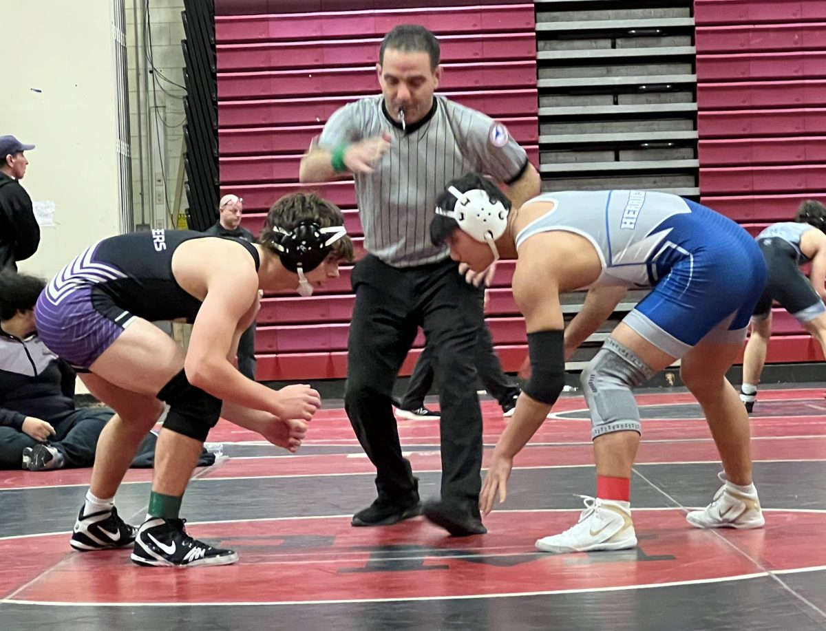 Students square off at a wrestling match that Herricks participated in.