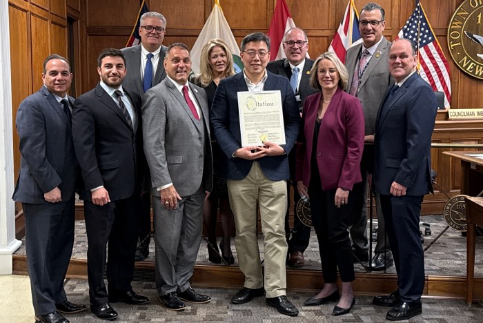 The Oyster Bay Town Board honored Samuel An (C.), the English Minister pastor at the Arumdaun Presbyterian Church in Bethpage, for his community service.