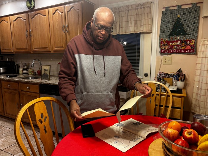 John Mobley looking through files in his kitchen