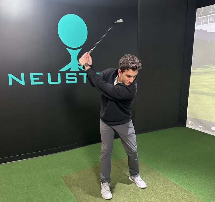 Former pro Mark Roder practices his swing in a Neustryk simulation bay.