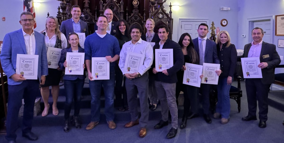 Ryan Schlotter (front row, third from left), president of the Oyster Bay–East Norwich Chamber of Commerce has worked hard for the communnity.