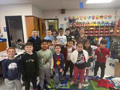 John Lewis Childs School kindergarten and sixth-grade students with Matthew Reid on the Day of Giving.