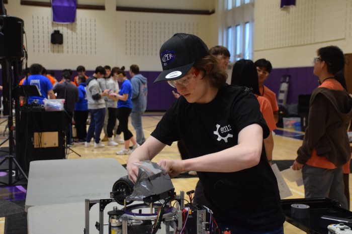 Locust Valley High School student Dylan Robson made repairs to their robot on the fly.
