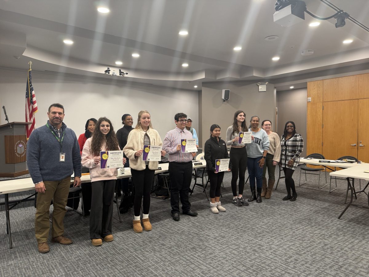 Carle Place High School students and Westbury Public Library board members.