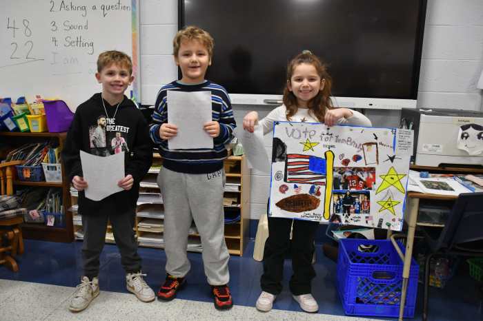 Second graders held their posters and speeches.