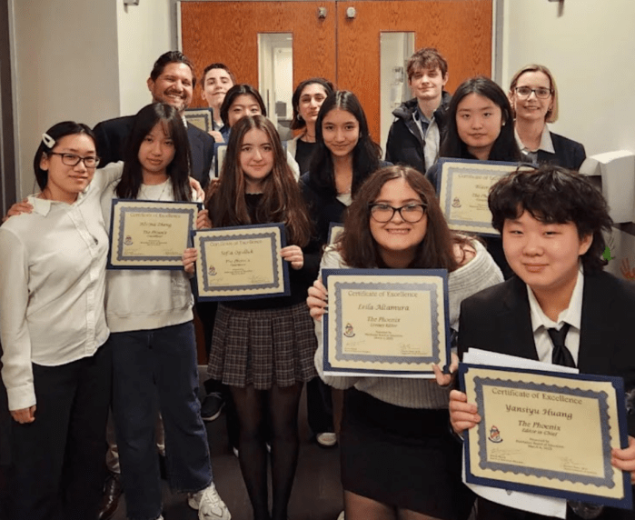 Manhasset students holding their certificates for literary magazine recognition