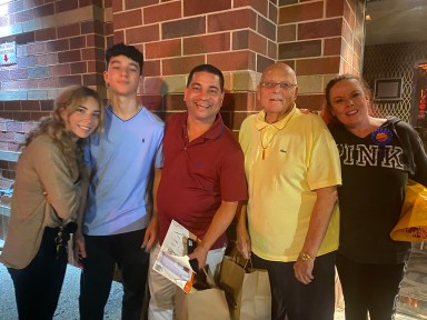 Jamie Greenberg (C.) and his family will be honored at the 20th anniversary Cooking for a Cure fundraiser.