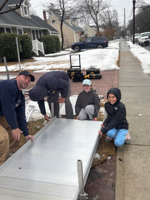 Volunteers helping build the ramp. 