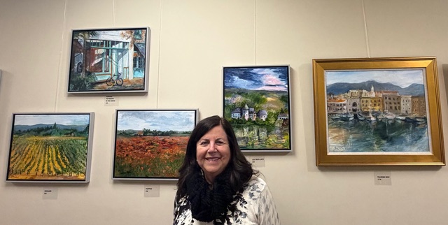 Betsy Schreiber with her work on display. 