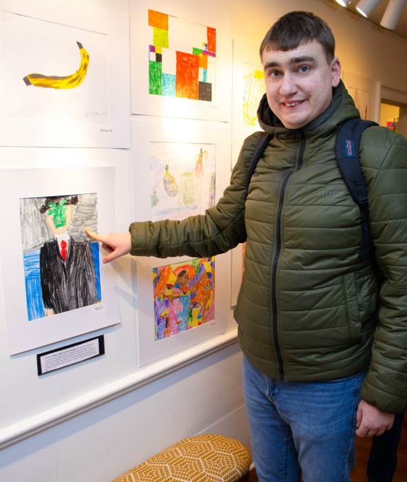 A Nicholas Center student showing his artwork.