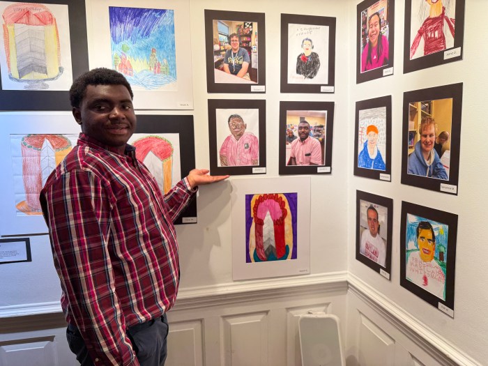 Javari posed next to his own self portrait that he created through the program.