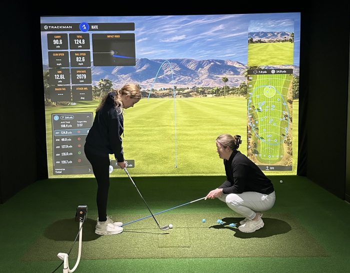 Instructor Emily Byrne, a former Division 1 golfer, teaches a young student at Neustryk,