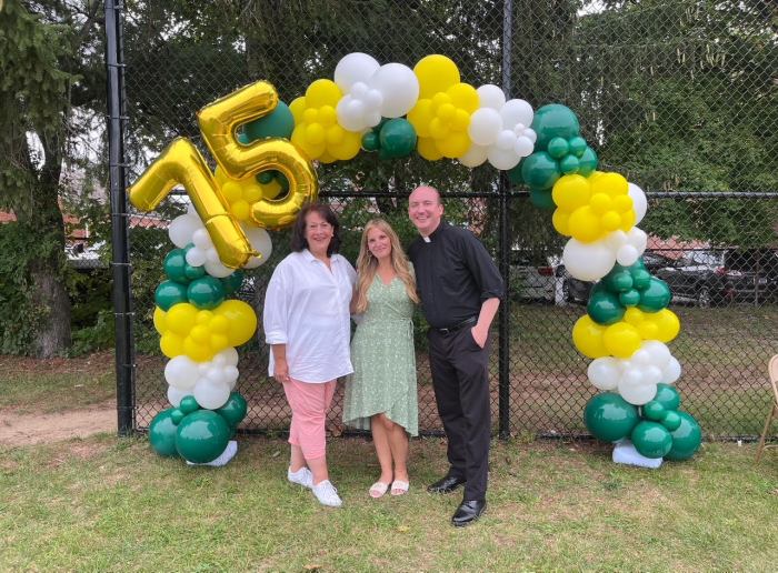Assistant principal, Barbara Graham, principal Josephine Guidice, and Fr. Michael Bissex, Pastor (L. to R.) at a 75th anniversary barbecue.