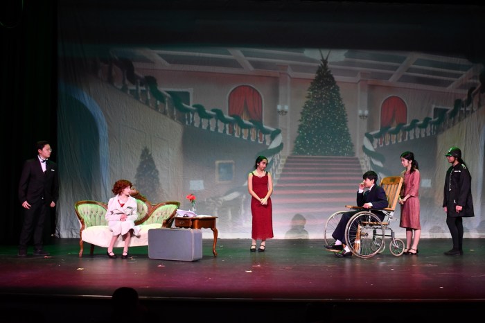 Students perform on stage for community members.