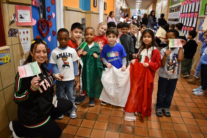Students carried the flag of Italy in an Olympic parade.