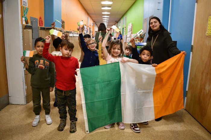 Students carried the flag of Ireland in an Olympic parade.