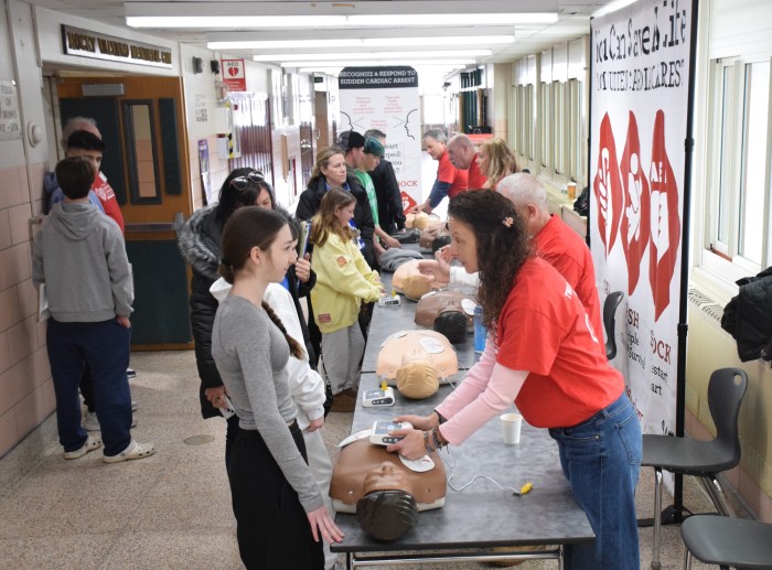 Volunteers taught students how to perform CPR and how to use an AED to save a life.