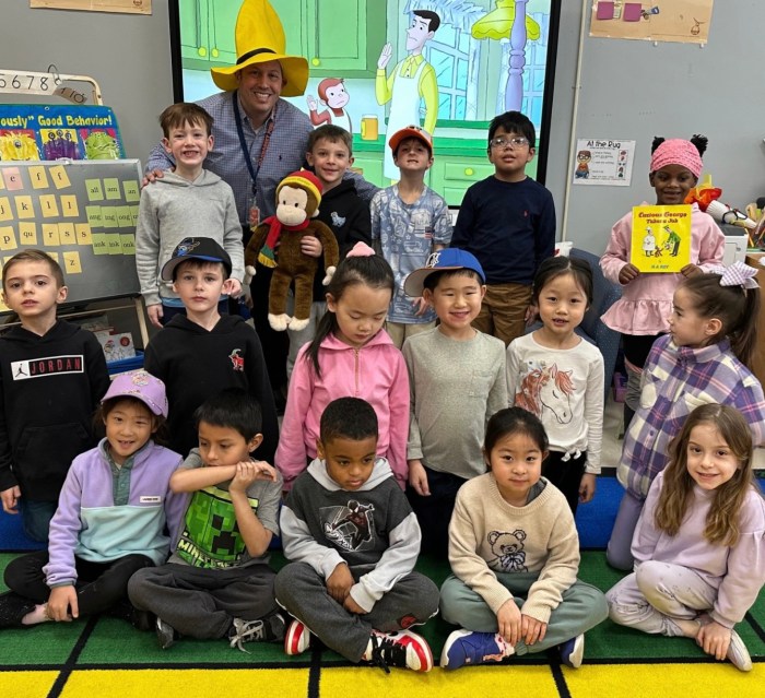 Principal Chad Altman wearing a yellow hat with Munsey Park first graders