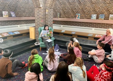 Sofia Ogulluk, a junior at Manhasset High School and a Shelter Rock alumna reads to elementary students.