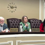 Council Member Dennis Walsh, Town Supervisor Jennifer DeSena, and Council Member Christine Liu (L. to R.) listen to Charlene Prounis during public comments