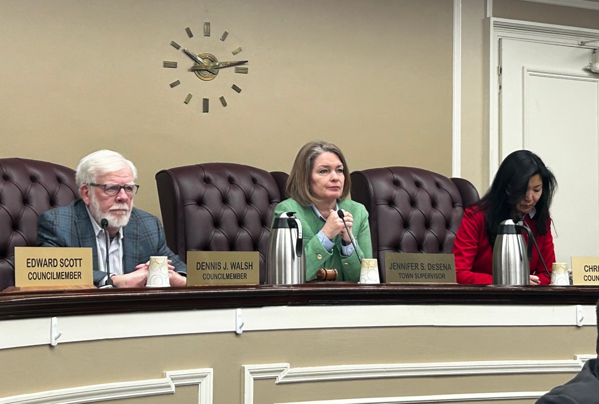 Council Member Dennis Walsh, Town Supervisor Jennifer DeSena, and Council Member Christine Liu (L. to R.) listen to Charlene Prounis during public comments