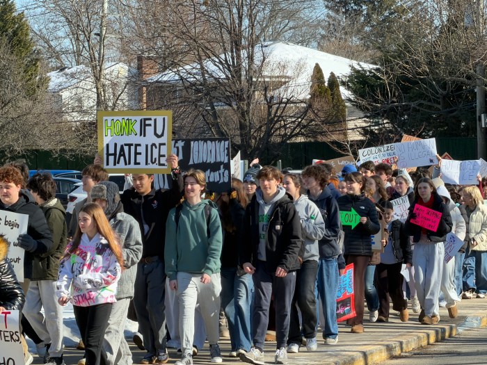Students walked from the front of the high school to the street.